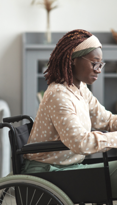 photo-of-a-young-Black-woman-in-a-wheelchair-sitting-at-her-desk-at-home-working-on-a-laptop-new-canva